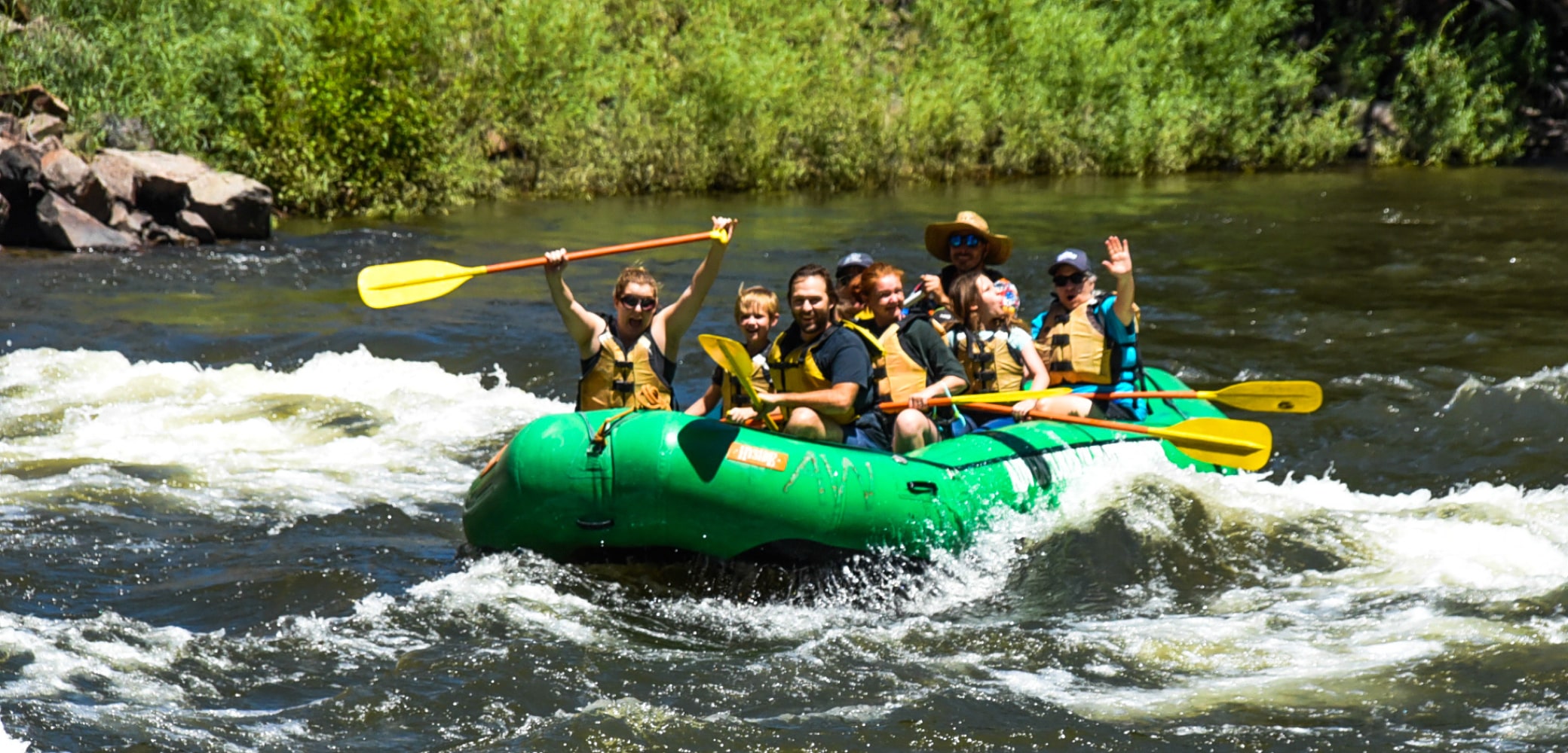Beginner rafting Colorado with people hitting some minor rapids