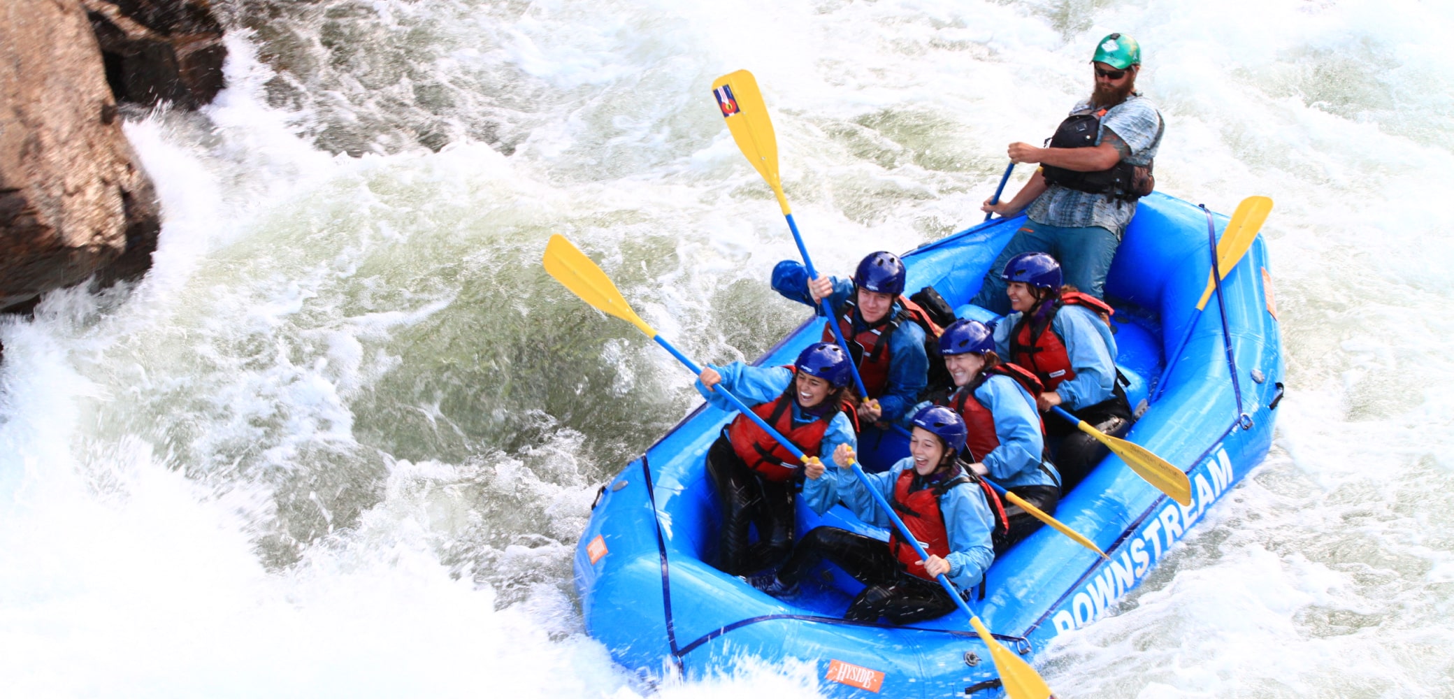 people navigating rapids on clear creek river rafting trip near Denver