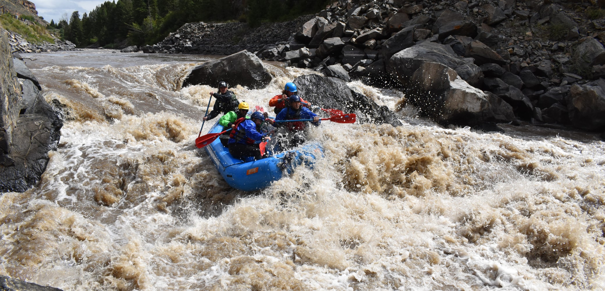 people in raft hitting rapids while gore canyon rafting in colorado