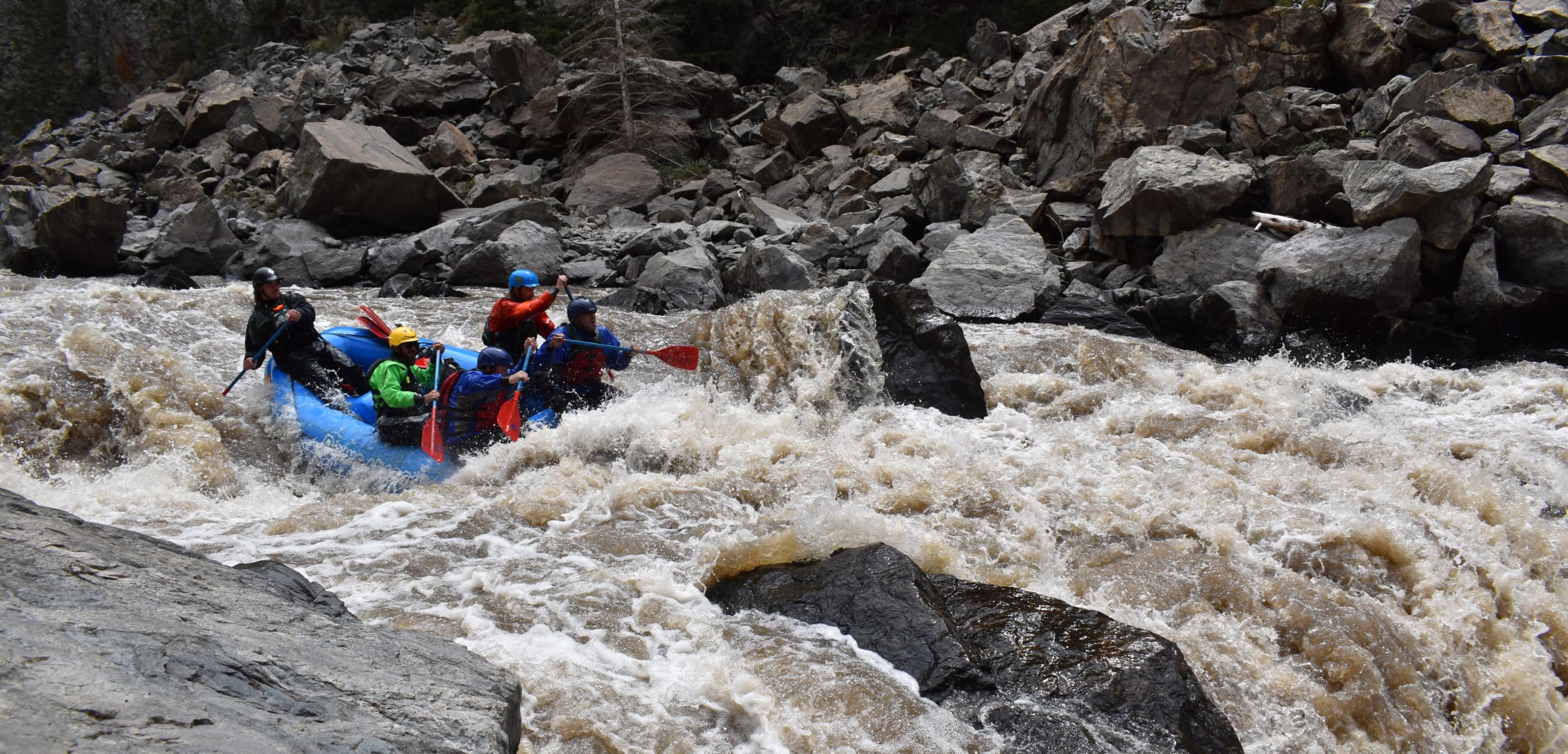 People on raft and rapids during gore canyon rafting trip