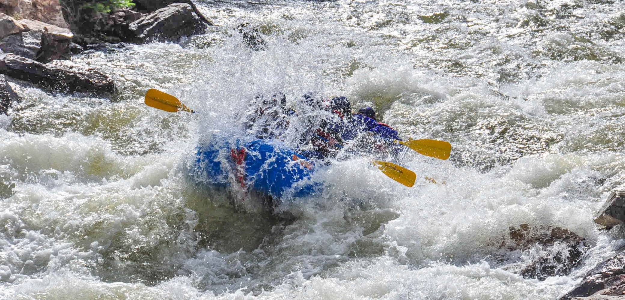 people getting splashed on an Advanced Clear Creek River Rafting trip