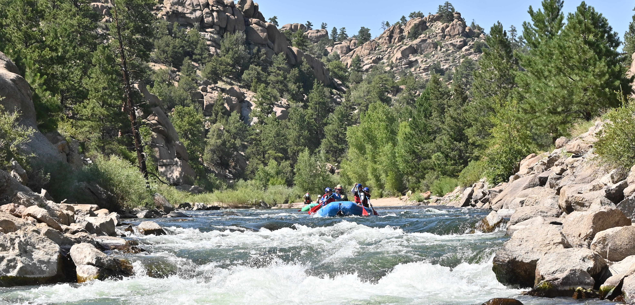 wide angle of people whitewater rafting the Arkansas River in Browns Canyon