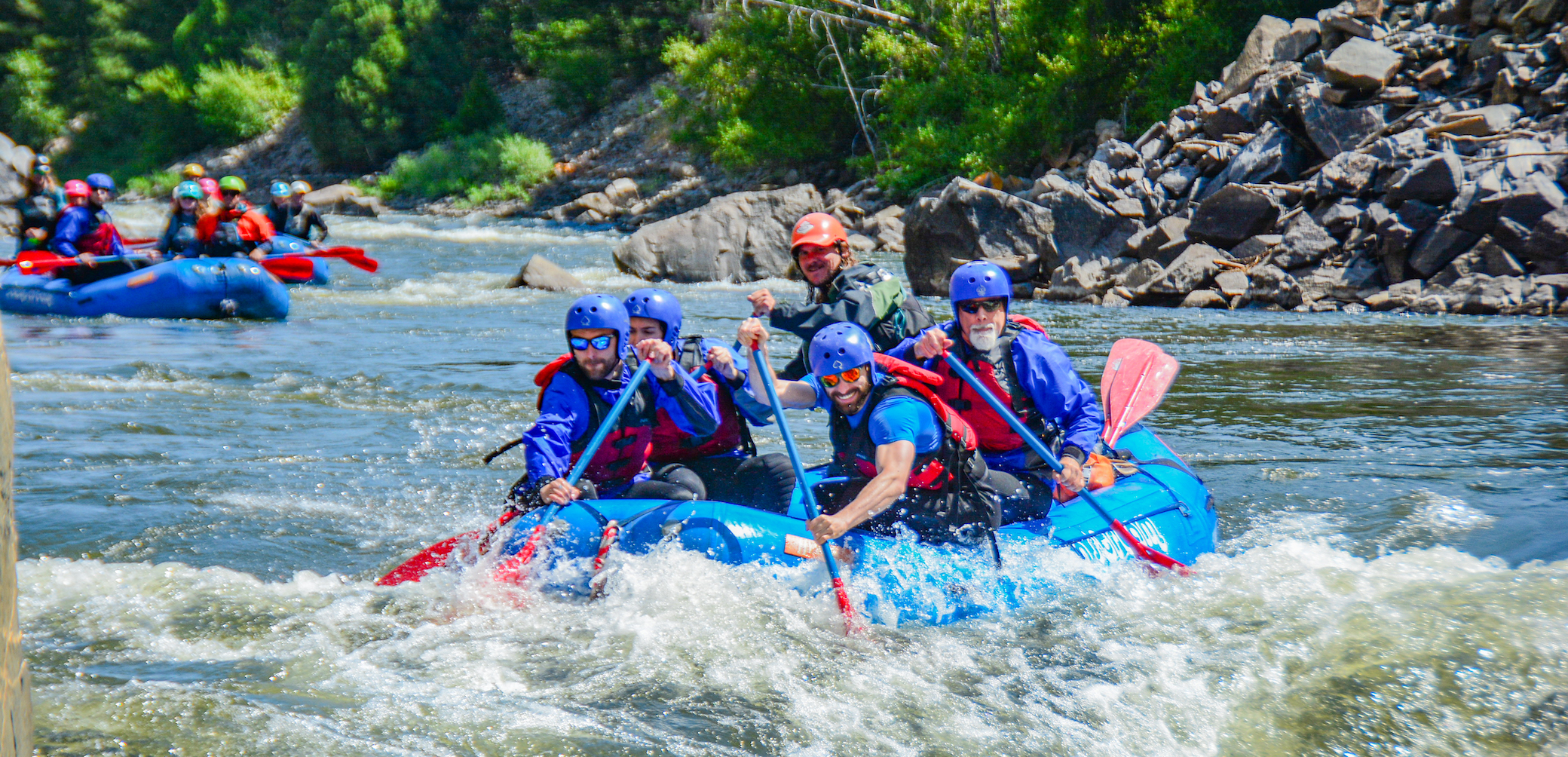 people smiling while navigating rapids on a Gore Canyon rafting trip