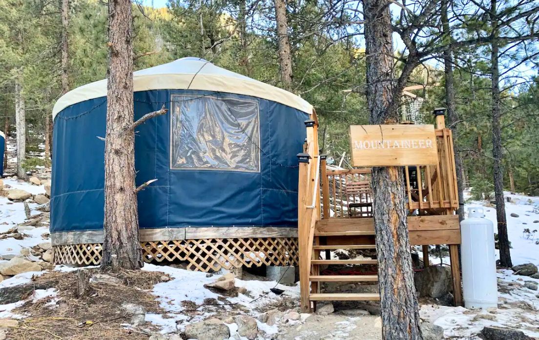 blue yurt set in trees near Denver, Colorado