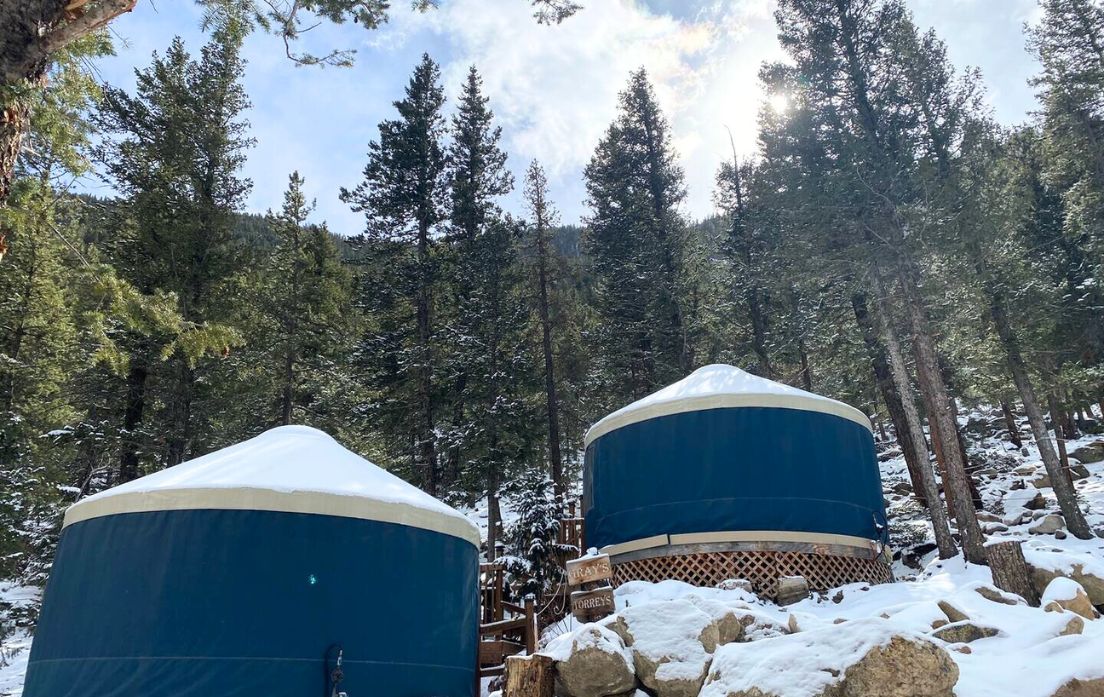 two yurts side by side in the snow for glamping near denver