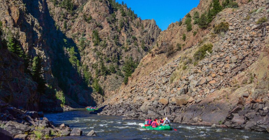 people rafting through a canyon on a guided trip