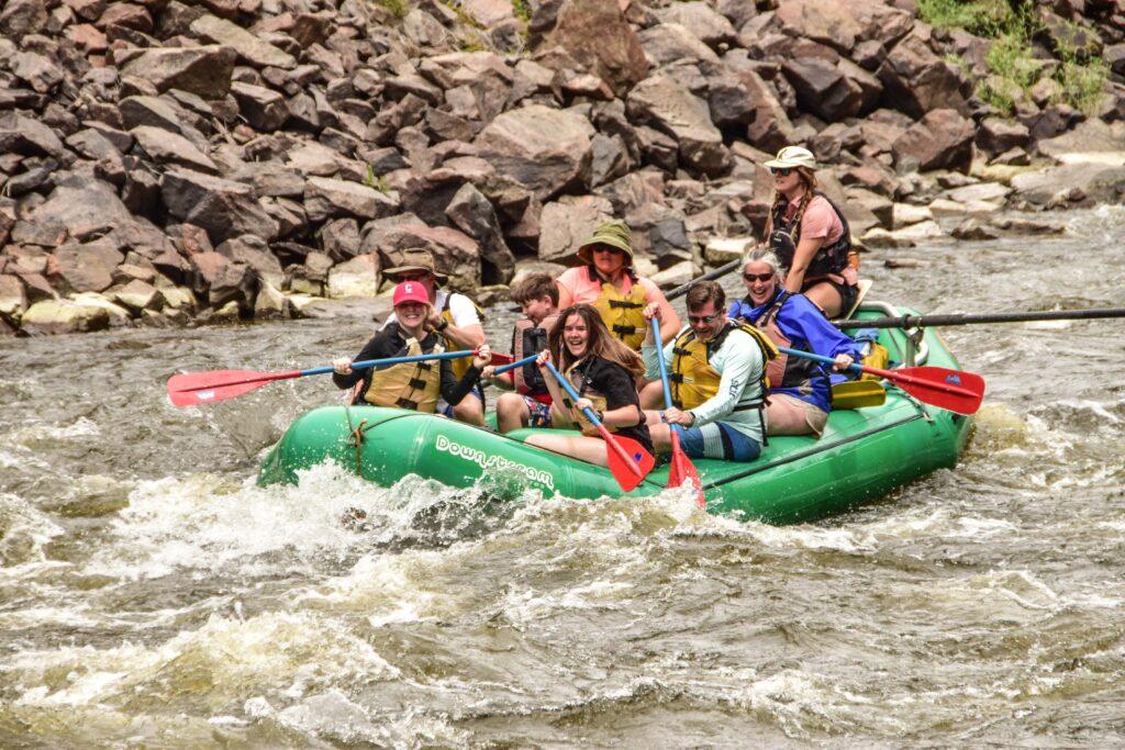 people in a green raft on the Colorado River with Downstream Adventures